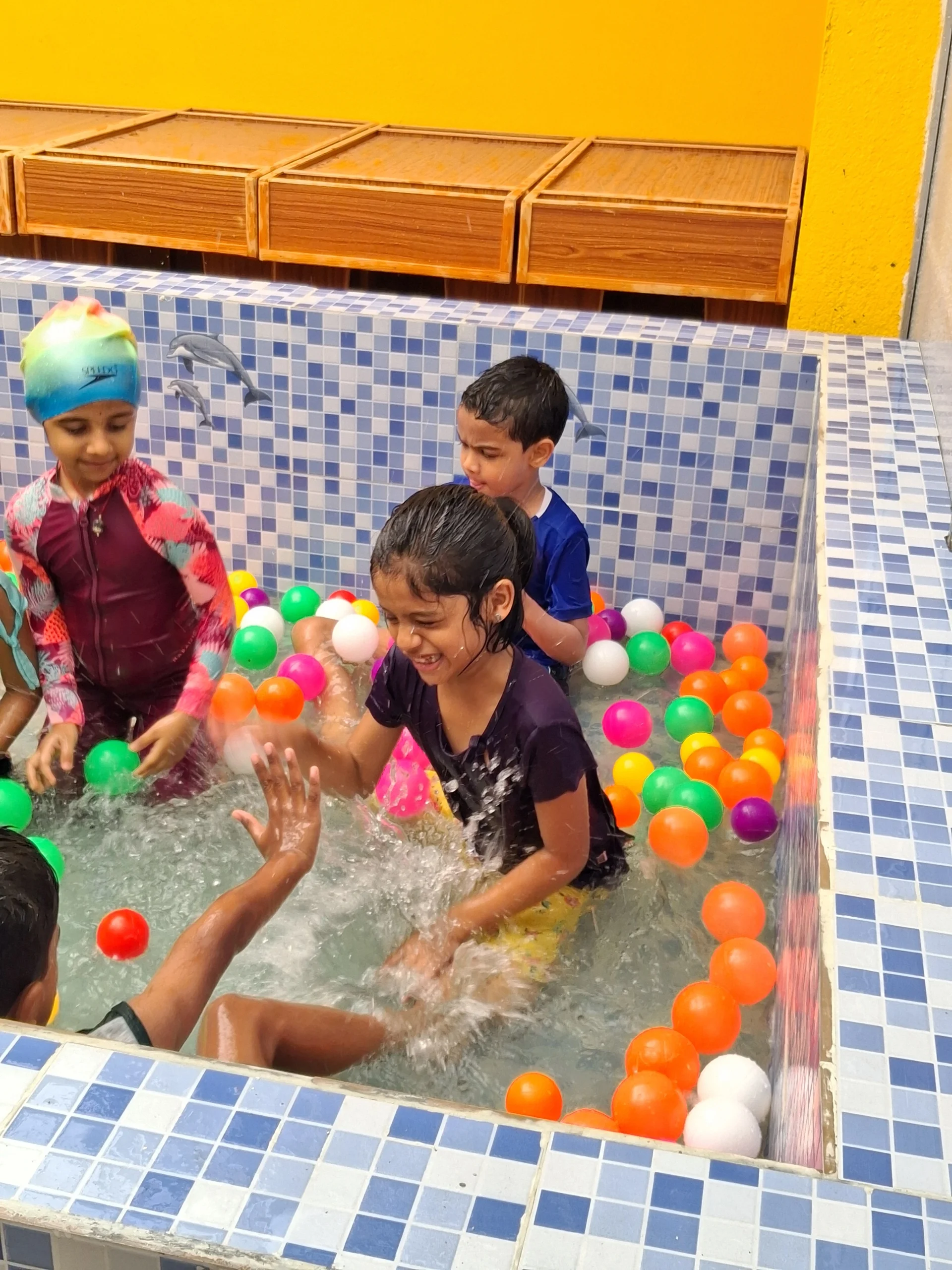 Children enjoying splash pool water play activity at our playgroup in Anna Nagar.